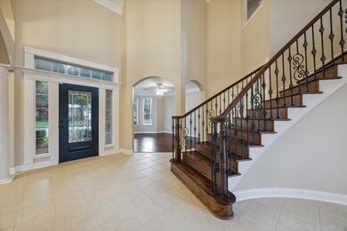 Looking back at the handsome refinished iron and glass front door with a view into the front office/living space