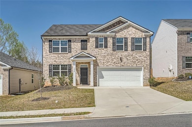View of front of home featuring concrete driveway,