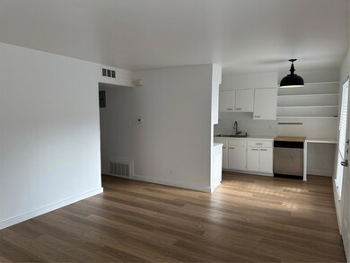 Kitchen featuring visible vents, a sink, dishwash