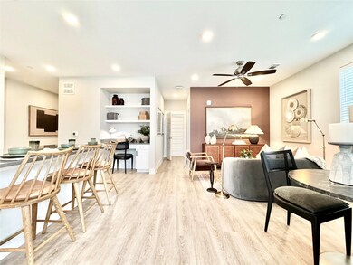 Living room featuring built in desk, ceiling fan, 