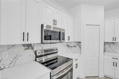 Kitchen featuring tasteful backsplash, light stone