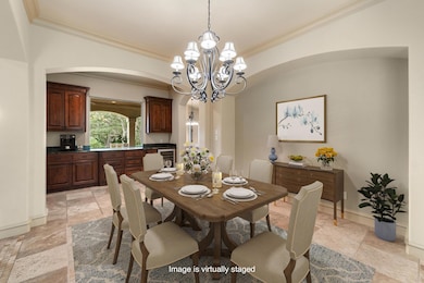 Dining room with ornamental molding, arched walkw