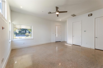 Unfurnished bedroom featuring baseboards, two clo
