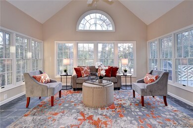 The sun room has slate floors and overlooks the wo