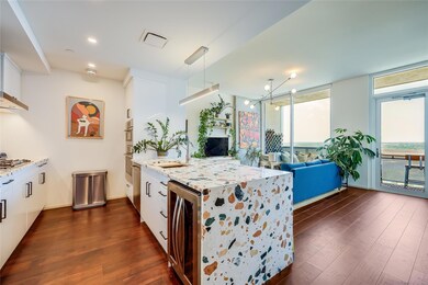 Kitchen with beverage cooler, a peninsula, dark w