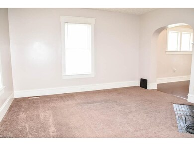 Living room with a corner fireplace.