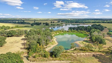 Aerial view featuring a rural view and a water vie