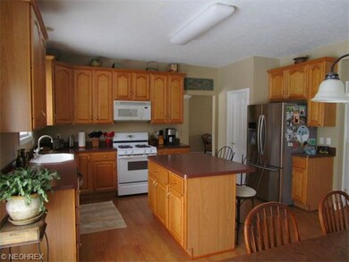 Kitchen features an island, newer stainless steel 