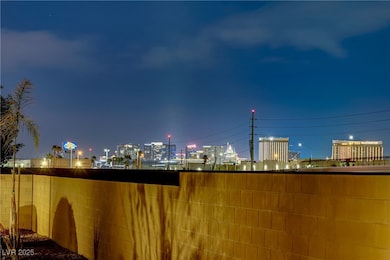 Patio at twilight with a view of city lights and f