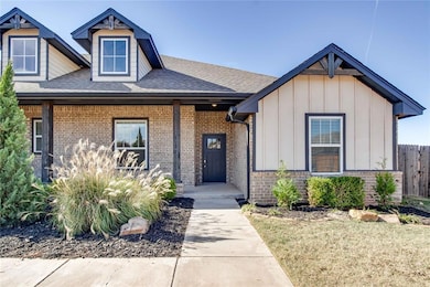 View of front of property featuring roof with shingles, board and batten siding, covered porch, and brick siding