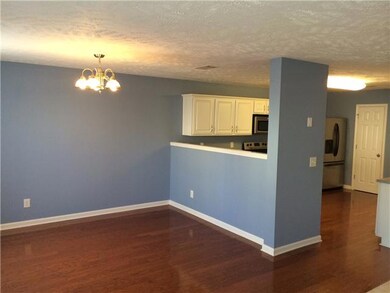 eat in are of the kitchen, open layout! notice the hardwood flooring all the kitchen and hallway!