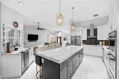 Kitchen with lofted ceiling, wall chimney range ho