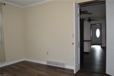 Dining room with eat-in kitchen to right. Doors of