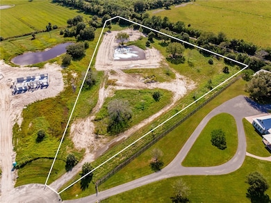 View of rural area featuring a nearby body of water and property parcel outlined