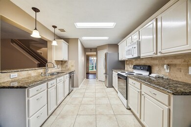 This kitchen features granite countertops, lots of