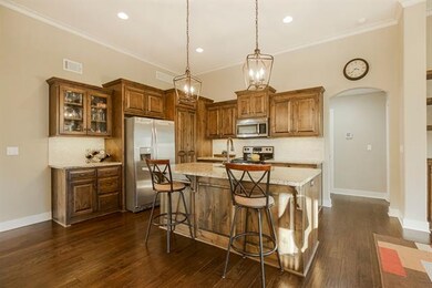 Large kitchen with island, under cabinet lighting,