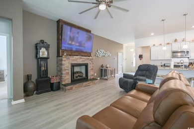 Living area featuring baseboards, light wood-style