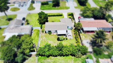 Aerial view of property and surrounding area featuring property parcel outlined