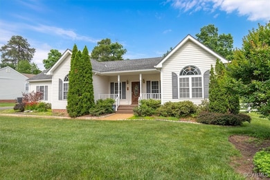 Ranch-style home with a porch, a front yard, and a