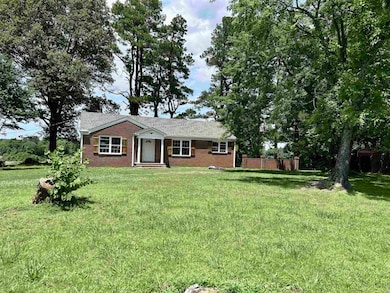 Ranch-style home with brick siding and a front lawn