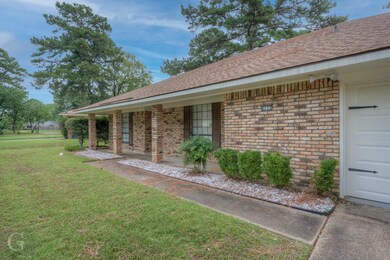 View of property exterior with a garage and a lawn