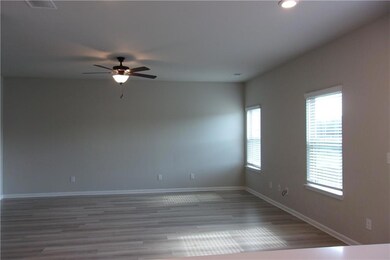 Unfurnished room with a ceiling fan, baseboards, wood finished floors, and recessed lighting