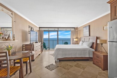 Bedroom with ornamental molding, freestanding refrigerator, a wall of windows, access to outside, and a textured wall