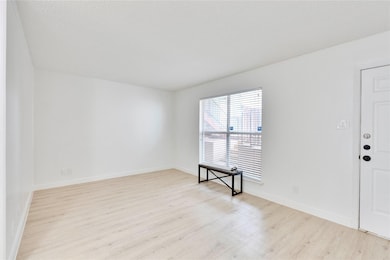 Empty room featuring wood finished floors and bas