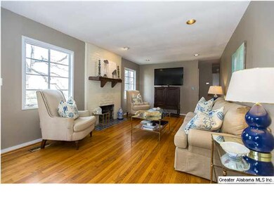 Large living room with hardwood floors & fireplace