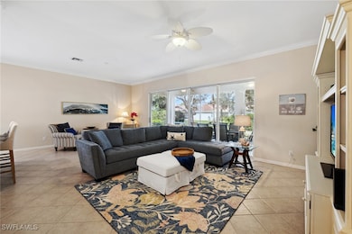Tiled living room featuring crown molding and ceil