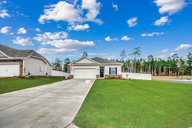Single story home featuring a front lawn and a gar