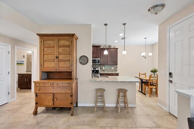 Looking from the living room toward the eat in kitchen, with breakfast bar and stools.