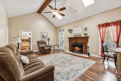 Den with vaulted ceiling and wood burning fireplace (can be connected to propane tank) and access to sunroom.