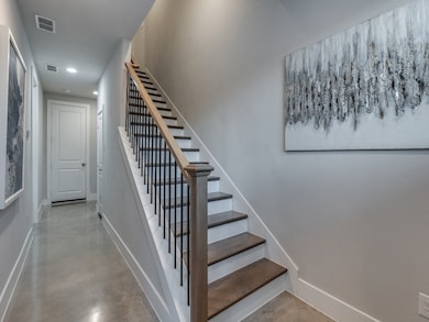 Stairway with concrete floors and recessed lighting