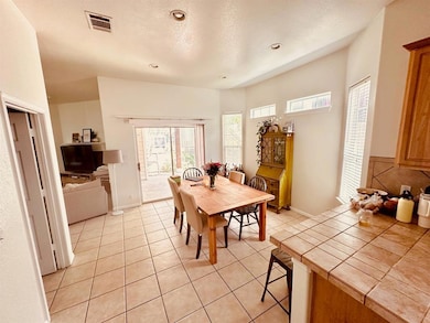Dining area featuring recessed lighting, light ti