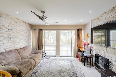 Living area featuring tile patterned floors, visib
