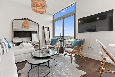 Living area with baseboards, a high ceiling, and 