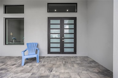 Entrance to property featuring french doors, stucc