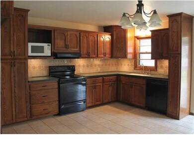 KITCHEN FEATURES: CUSTOM BUILT CABINETS, SOLID SUR