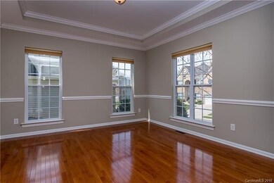 Formal dining room with large windows, trey ceilin