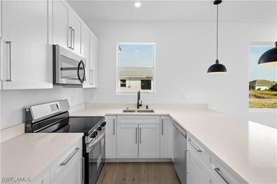 Kitchen featuring sink, decorative light fixtures,