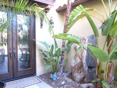 front entry with water feature and palm trees