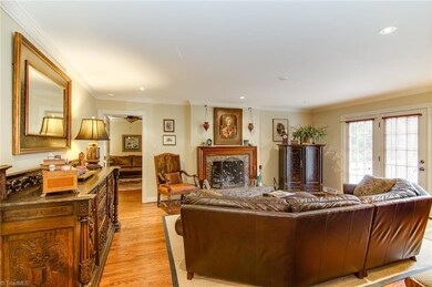 Den  - french doors leading to deck and large backyard.  You can also see the entrance to first floor master.  Note hardwood floors.