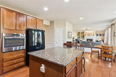 The oversized center island serves as a perfect casual breakfast bar and gathering spot. This open layout offers easy entertaining access to the family room and dining area.