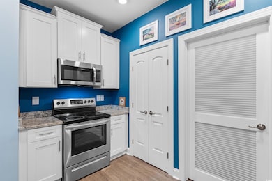 Kitchen with light stone countertops, stainless st