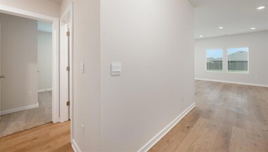 Hallway featuring light wood-style floors and recessed lighting