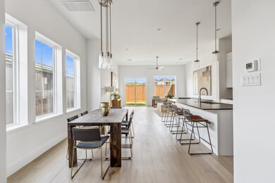 The dining area features a statement designer ligh