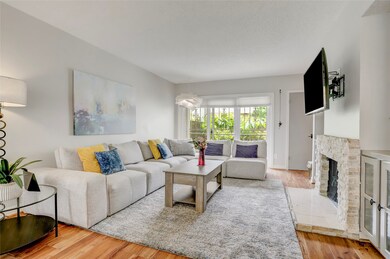 Another view of the living area with cozy fireplac