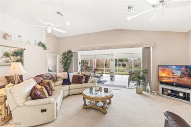 Carpeted living room featuring visible vents, rece