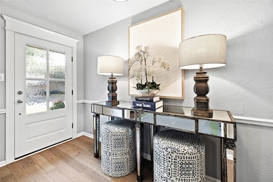 Entryway with hardwood / wood-style flooring and a textured wall